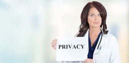 woman holding sign for HIPAA Privacy
